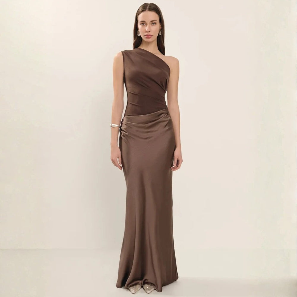 Woman wearing a brown one shoulder satin maxi evening dress