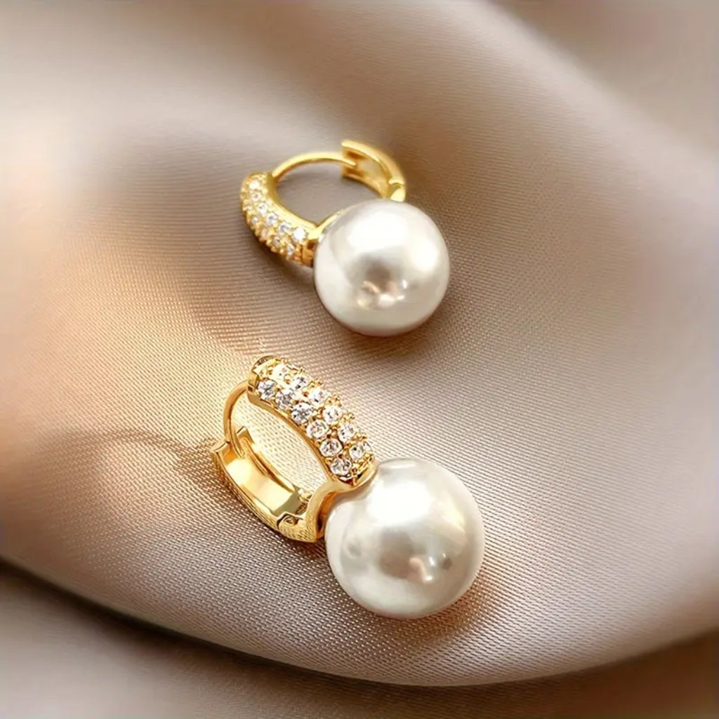 woman wearing gold pearl drop earrings elegant look