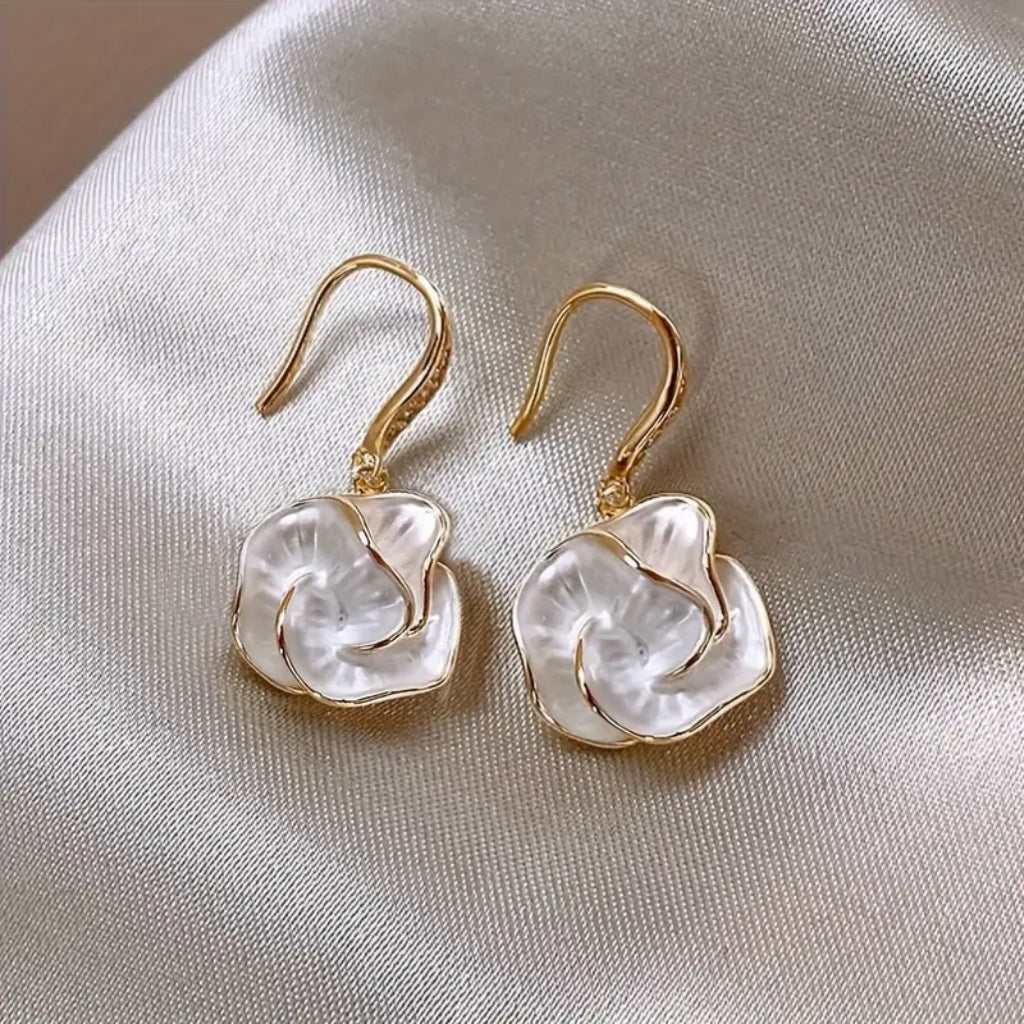 close up of white flower drop earrings detail