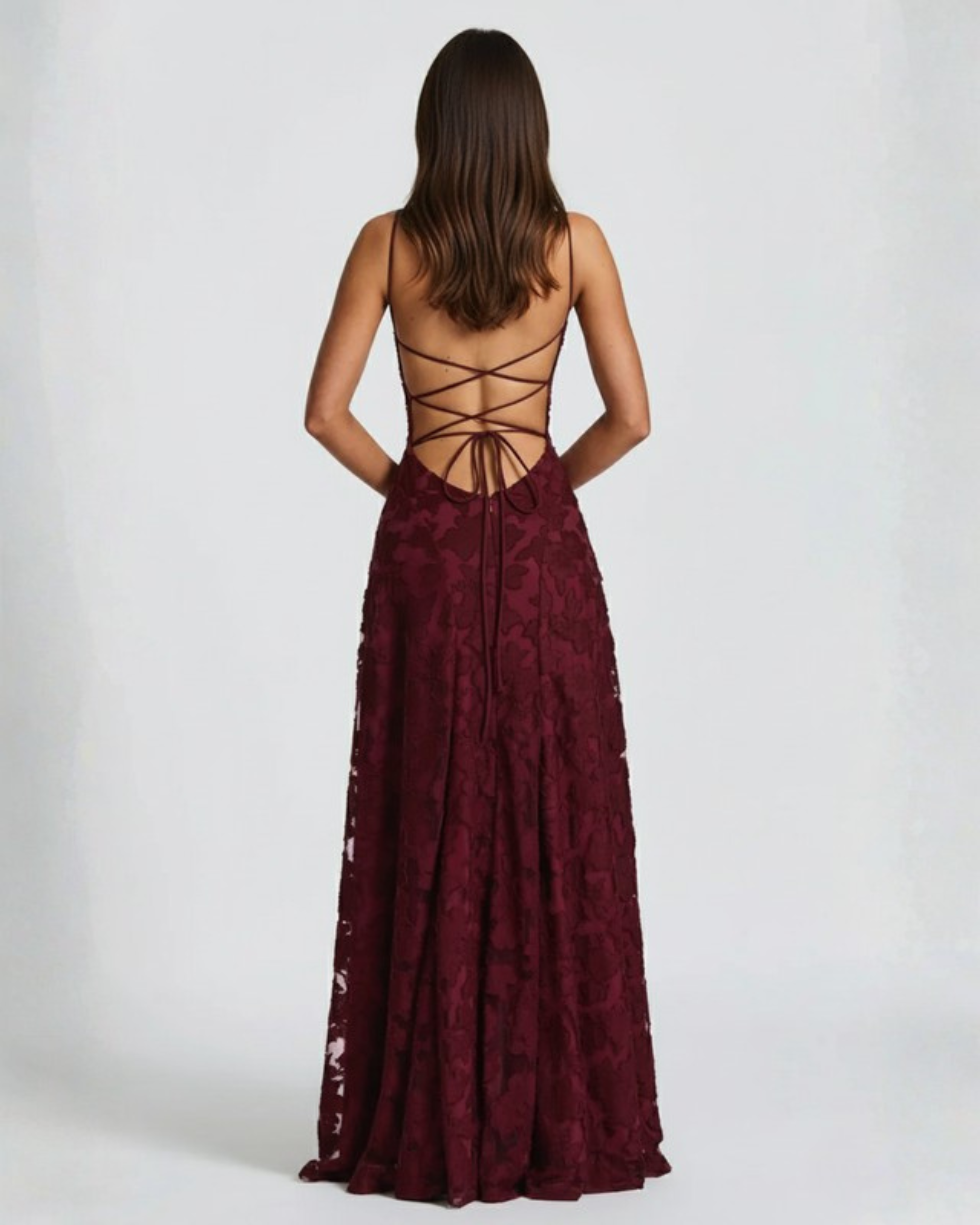 Burgundy lace dress with open back on a white background