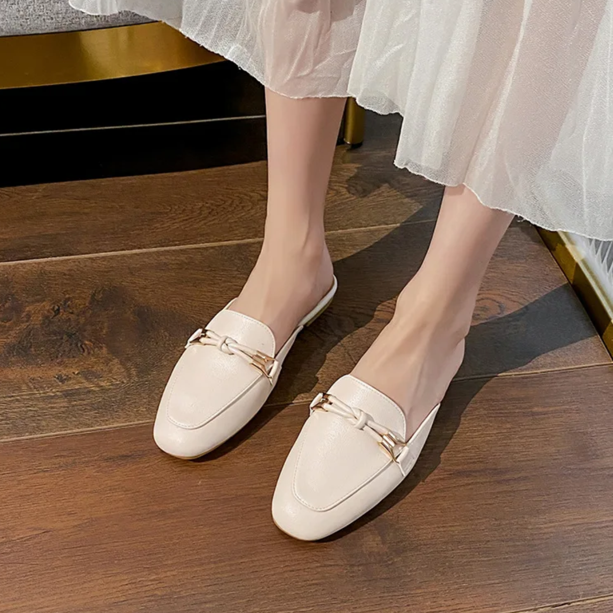 Pair of elegant loafer mules displayed