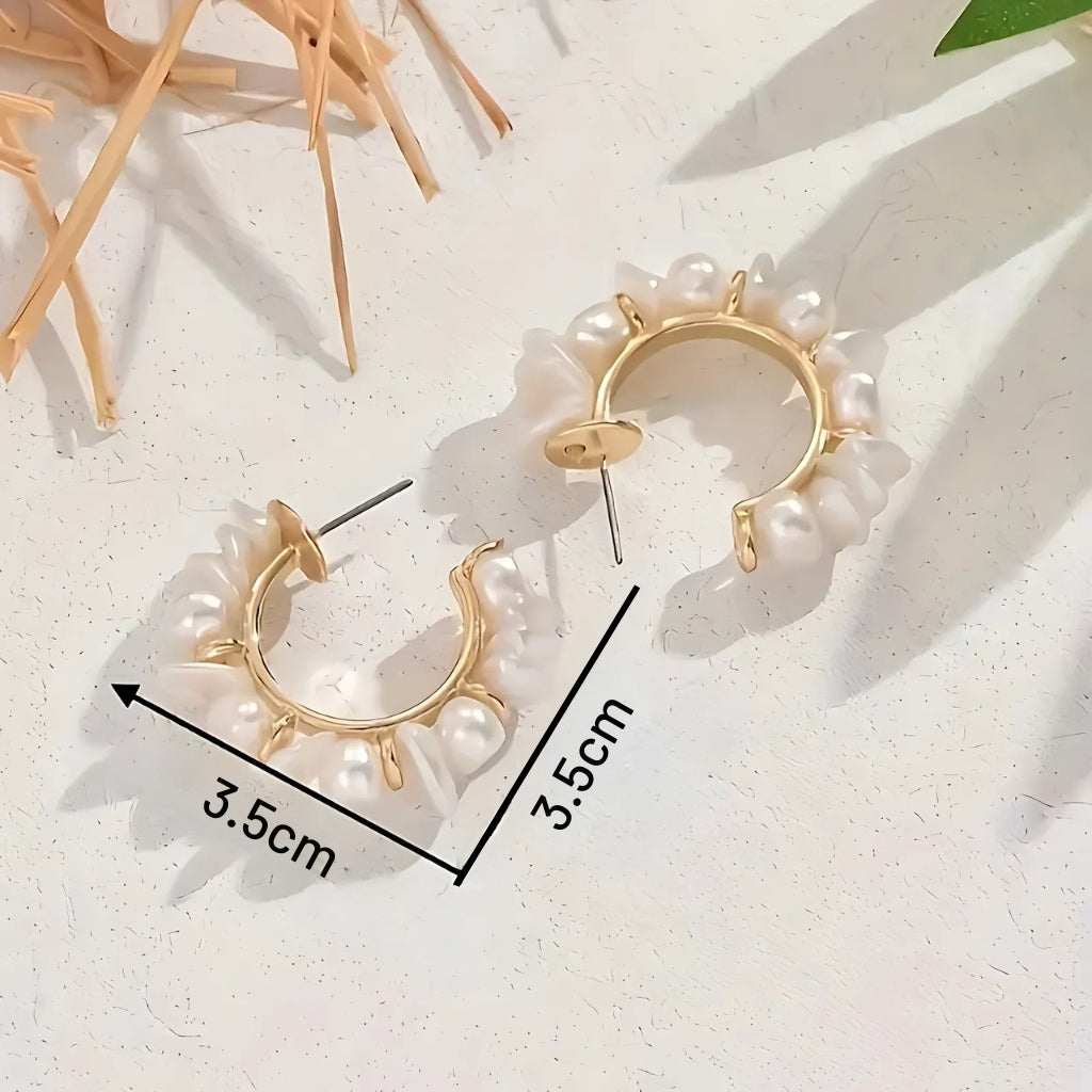 Woman wearing modern pearl hoop earrings