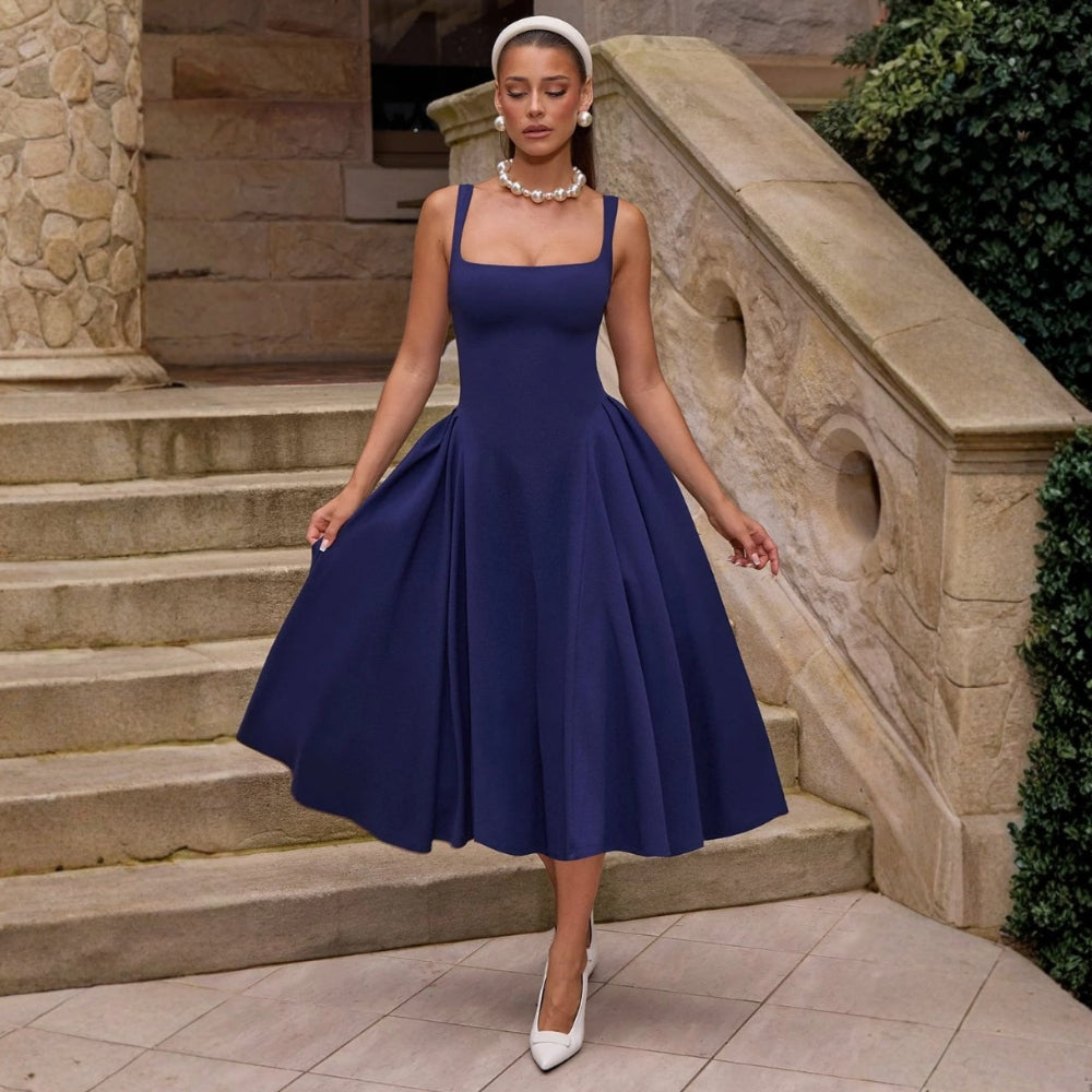 Woman wearing a navy square neck midi dress with full skirt