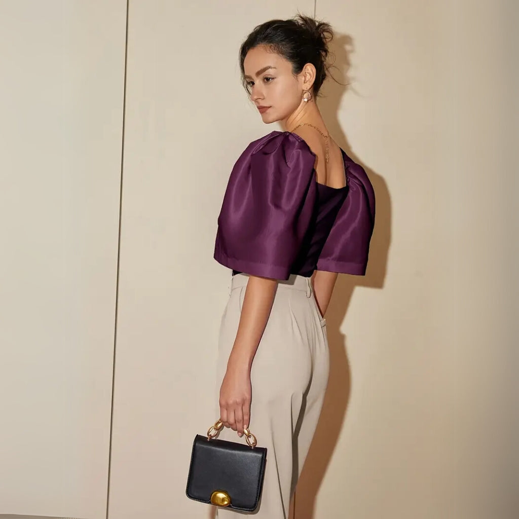 Detail view of puff sleeve and neckline