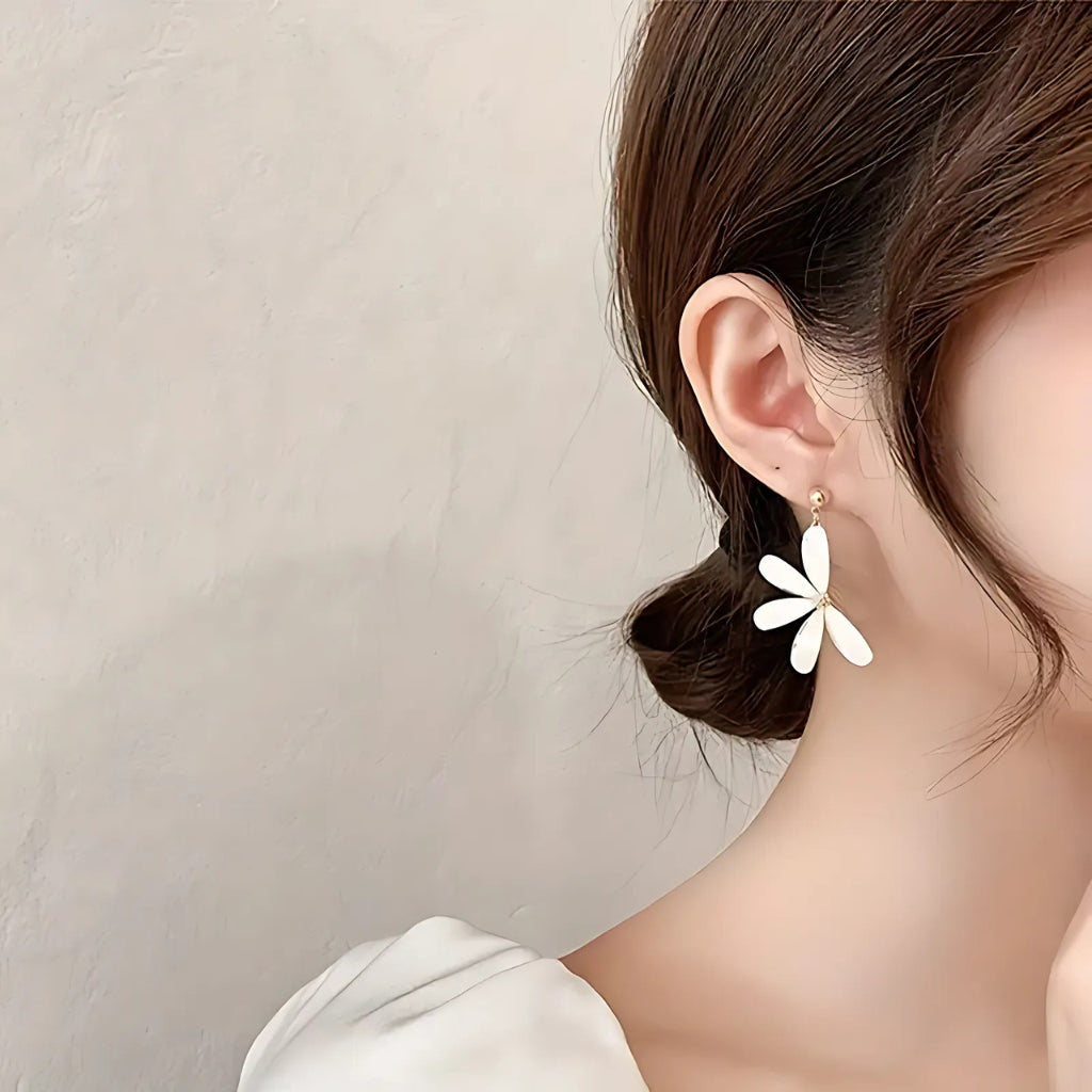 Close up gold flower earrings