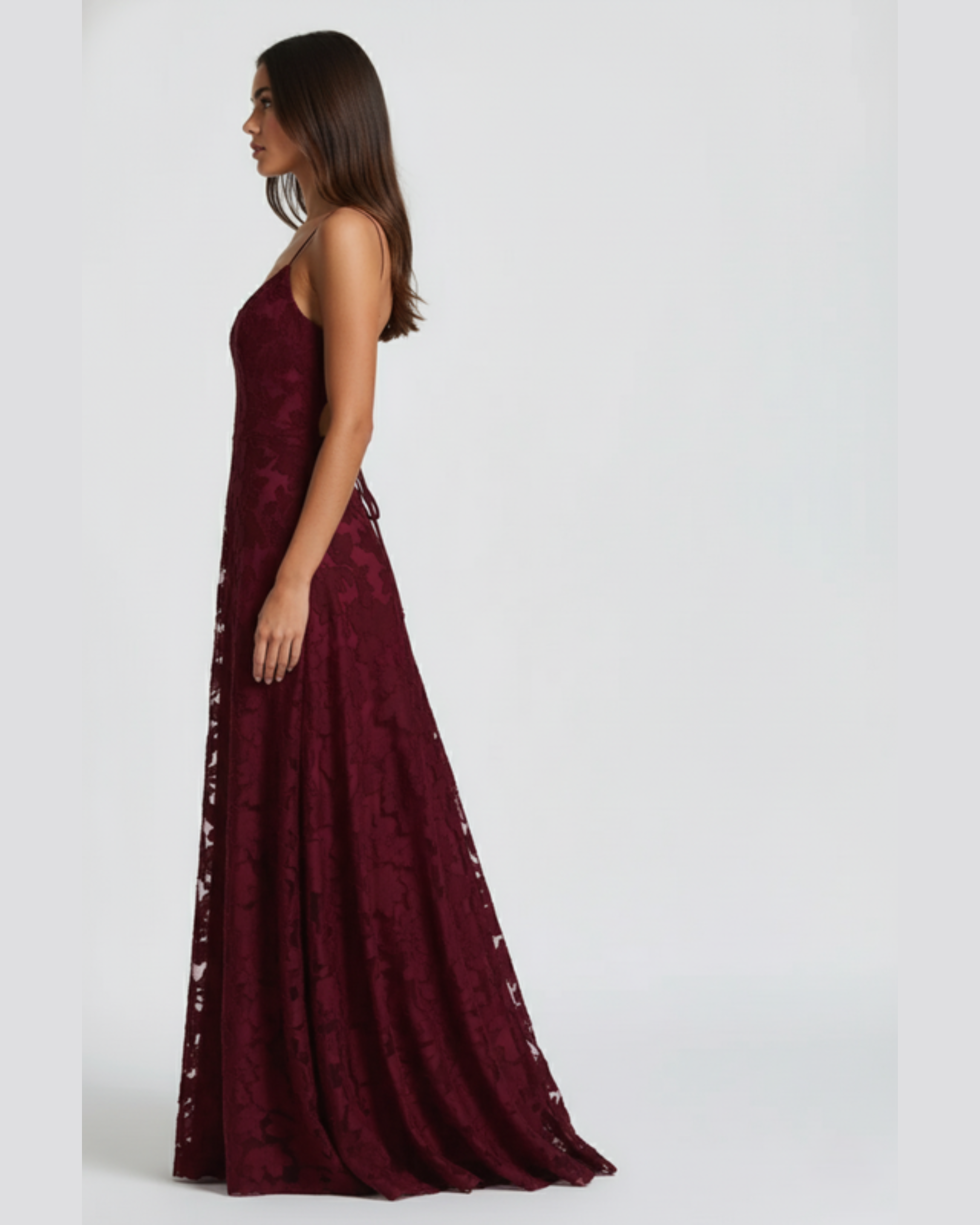Burgundy evening gown with lace details on a white background