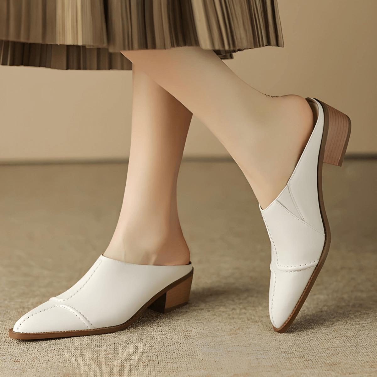 Beige mule worn on foot
