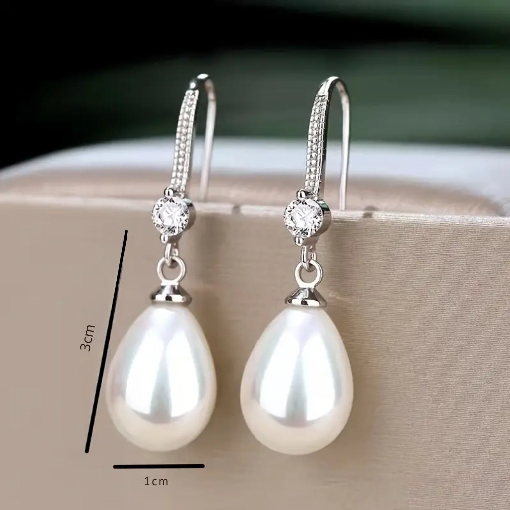 woman wearing pearl drop earrings elegant look