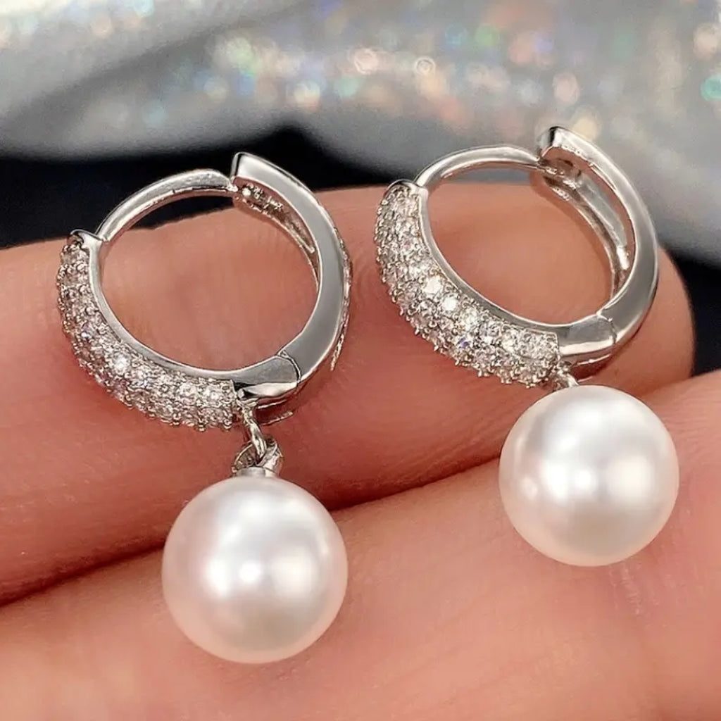 woman wearing pearl hoop earrings elegant look