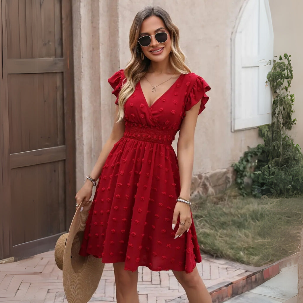 Woman wearing a red V-neck midi dress with ruffle sleeves