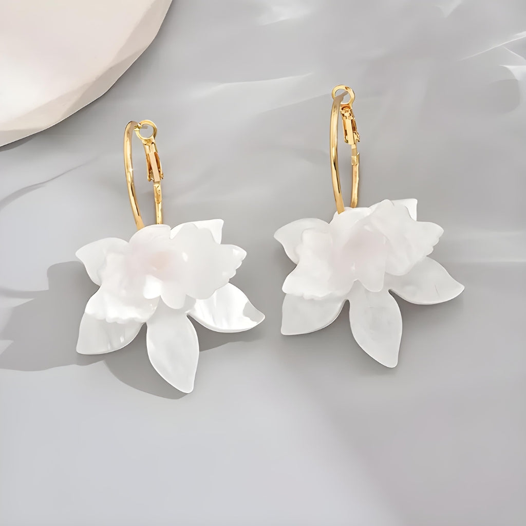 woman wearing minimalist white floral gold plated earrings outfit style