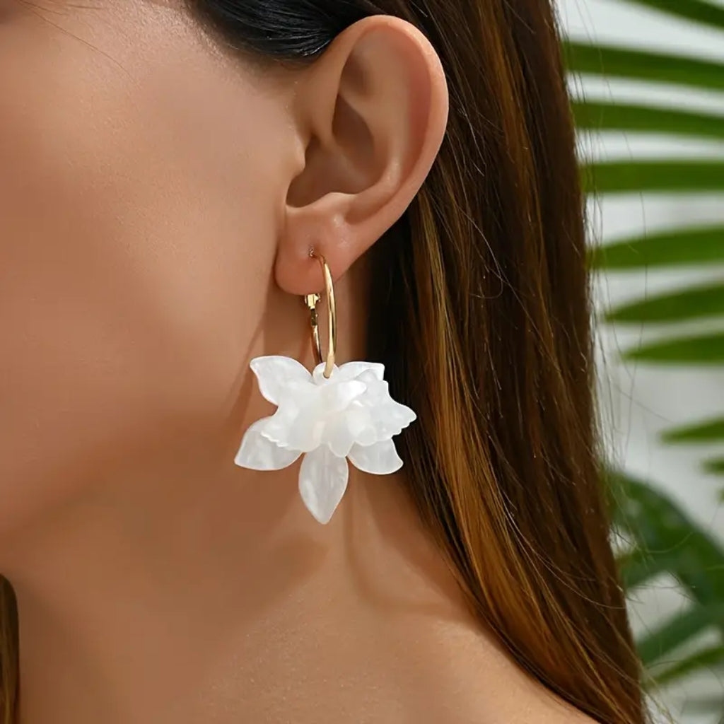 close up of white floral gold plated stud earrings for women